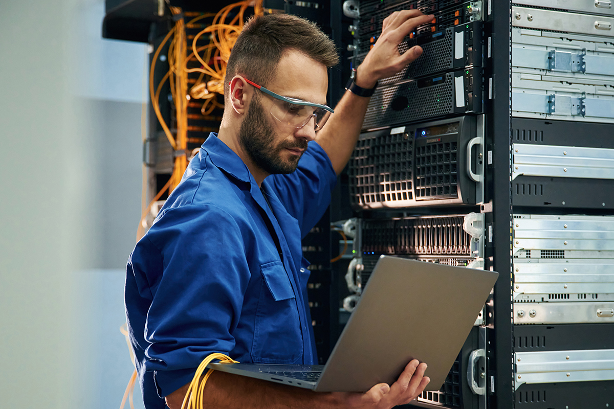 An engineer setting up a networking hub.