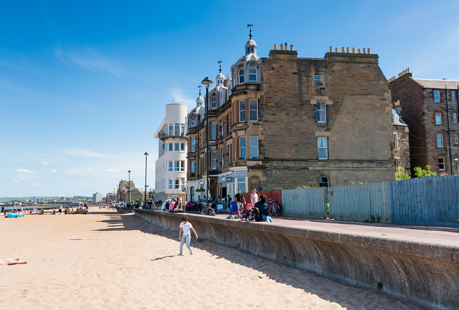 Looking down the beach at portobello, the sea is just out of shot on the left and the gable end of a victorian building is filling the picture to the right.
